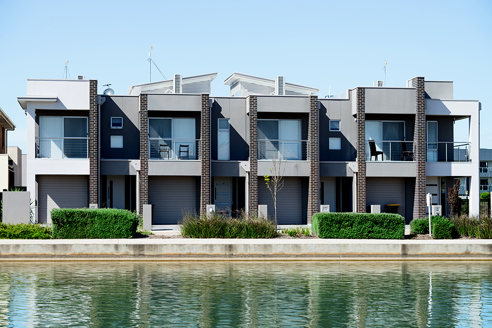 A modern, suburban multiplex housing building.